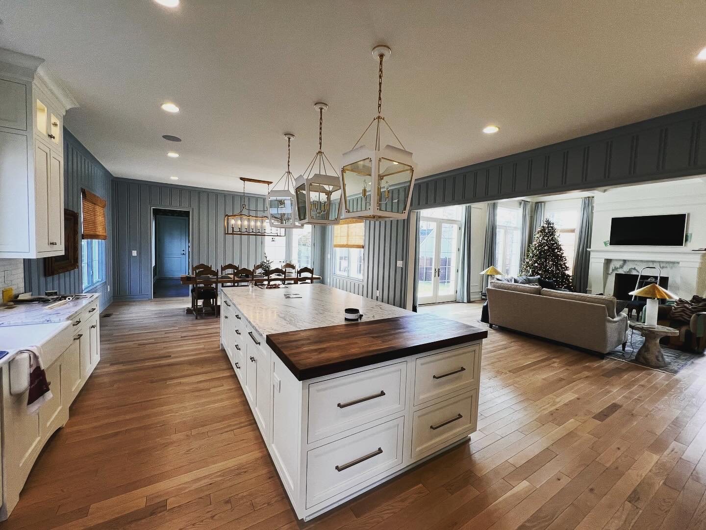 Painted blue beadboard walls in open-concept kitchen and dining room
