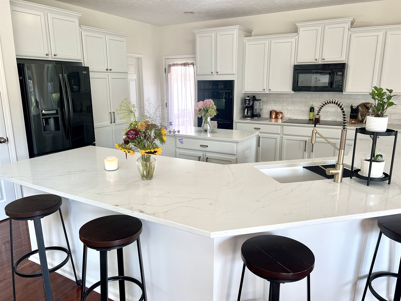 Refinished white kitchen with island and bar stools